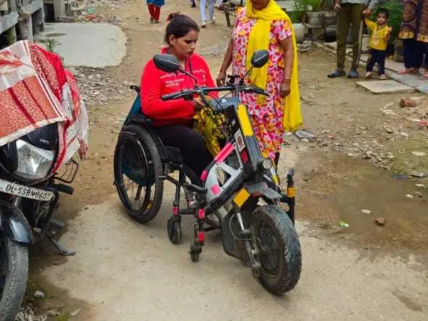 Arti, a GigWA member, with her mobility scooter
